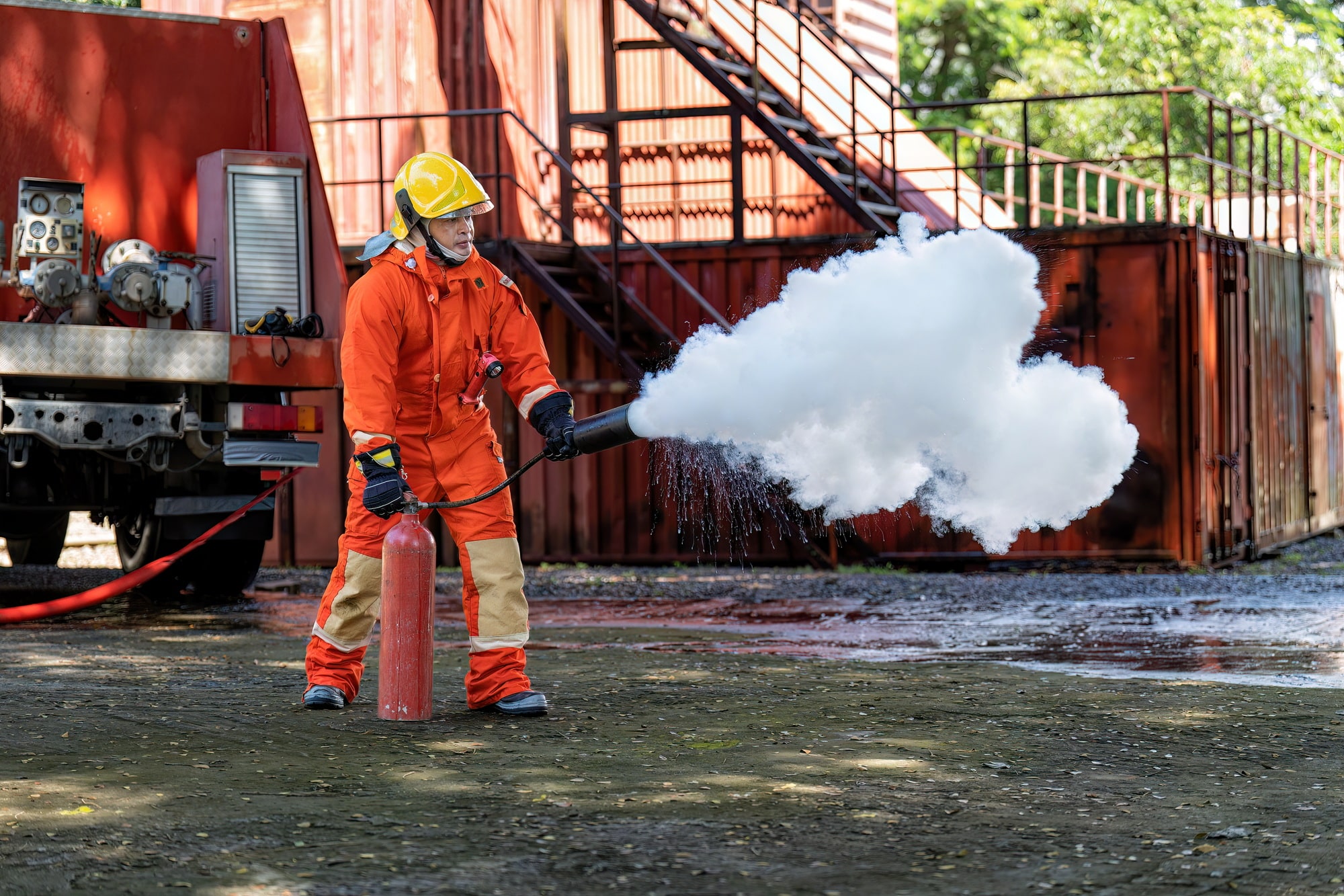 Fireman wearing fire protection suite and oxygen tank exercise hold extinguisher tank and pray